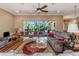 Bright living room with hardwood floors, comfortable seating, and sliding doors to the outdoor patio at 2630 Grand Lakeside Dr, Palm Harbor, FL 34684