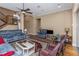 Comfortable living room featuring hardwood floors, natural light, and staircase access at 2630 Grand Lakeside Dr, Palm Harbor, FL 34684