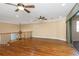 An airy loft with hardwood floors, ceiling fans, a decorative chandelier and balcony access at 2630 Grand Lakeside Dr, Palm Harbor, FL 34684