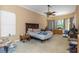 Large main bedroom features a ceiling fan, carpet, and a serene atmosphere at 2630 Grand Lakeside Dr, Palm Harbor, FL 34684