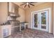 Outdoor kitchen featuring stainless steel appliances, including a grill and refrigerator, on a brick patio at 2630 Grand Lakeside Dr, Palm Harbor, FL 34684