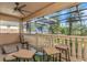 Screened patio with seating area overlooking lush green foliage and water views at 2630 Grand Lakeside Dr, Palm Harbor, FL 34684