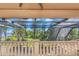 Screened patio featuring beautiful water views and lush outdoor scenery, creating a peaceful retreat at 2630 Grand Lakeside Dr, Palm Harbor, FL 34684