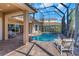 Screened-in pool and spa area with brick patio, perfect for outdoor relaxation and entertaining at 2630 Grand Lakeside Dr, Palm Harbor, FL 34684