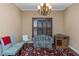 Cozy sitting room with natural light, comfortable seating, and a decorative rug on hardwood floors at 2630 Grand Lakeside Dr, Palm Harbor, FL 34684