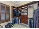 Organized walk-in closet with custom shelving, drawers, and hanging rods, illuminated by natural light at 2630 Grand Lakeside Dr, Palm Harbor, FL 34684
