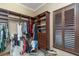 Spacious walk-in closet with custom shelving, drawers, and hanging rods illuminated by natural light at 2630 Grand Lakeside Dr, Palm Harbor, FL 34684