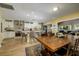 Open-concept kitchen with white cabinets, stainless steel appliances, and breakfast bar at 29844 Baywood Ln, Wesley Chapel, FL 33543