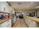 Bright kitchen with granite countertops, stainless steel appliances and open view to living room at 29844 Baywood Ln, Wesley Chapel, FL 33543