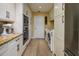 Bright kitchen with granite countertops, stainless steel appliances and laundry room at 29844 Baywood Ln, Wesley Chapel, FL 33543