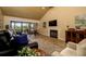 Comfortable living room featuring a fireplace, sliding doors, and neutral decor at 29844 Baywood Ln, Wesley Chapel, FL 33543