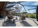 Enjoy this shaded screened in patio with outdoor seating and a golf course view at 29844 Baywood Ln, Wesley Chapel, FL 33543