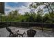 Outdoor deck with chairs featuring a scenic view of lush greenery at 2997 Eagle Estates E Cir, Clearwater, FL 33761