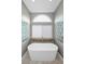 Elegant bathroom features a standalone tub and glass block windows at 2997 Eagle Estates E Cir, Clearwater, FL 33761
