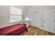 Cozy bedroom with a large window, closet, and hardwood floors at 2997 Eagle Estates E Cir, Clearwater, FL 33761