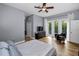 Cozy bedroom with hardwood floors, balcony access, and en-suite bathroom at 2997 Eagle Estates E Cir, Clearwater, FL 33761