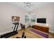 Bright and airy room with a treadmill, TV, and workout area at 2997 Eagle Estates E Cir, Clearwater, FL 33761