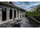 Back deck with outdoor seating featuring a scenic view of lush greenery and trees at 2997 Eagle Estates E Cir, Clearwater, FL 33761
