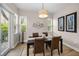 Bright dining room featuring wood floors, stylish lighting, and decor perfect for entertaining at 2997 Eagle Estates E Cir, Clearwater, FL 33761