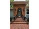 Arched front door with brick surround and decorative lighting at 2997 Eagle Estates E Cir, Clearwater, FL 33761