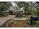 Single story home featuring a brick entrance, large driveway and landscaped yard at 2997 Eagle Estates E Cir, Clearwater, FL 33761
