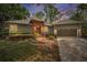 Charming single-story home with landscaped front yard, brick accents, and attached two car garage at 2997 Eagle Estates E Cir, Clearwater, FL 33761