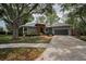 Well-maintained single-story home with a two-car garage and mature landscaping at 2997 Eagle Estates E Cir, Clearwater, FL 33761