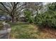 Well-maintained front yard featuring mature trees and lush greenery at 2997 Eagle Estates E Cir, Clearwater, FL 33761