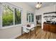 Bright kitchen nook with views of backyard, white modern table and wood floors at 2997 Eagle Estates E Cir, Clearwater, FL 33761