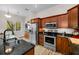Kitchen featuring wood cabinets, stainless steel appliances, and granite countertops at 2997 Eagle Estates E Cir, Clearwater, FL 33761