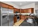 Cozy kitchen with wood cabinetry, stainless steel appliances, and granite countertops at 2997 Eagle Estates E Cir, Clearwater, FL 33761