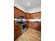 Well-equipped kitchen with stainless steel appliances, wood cabinets, and granite countertops at 2997 Eagle Estates E Cir, Clearwater, FL 33761