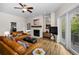 Inviting living room with a fireplace, hardwood floors, and access to an outdoor balcony at 2997 Eagle Estates E Cir, Clearwater, FL 33761