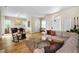 Bright living room with hardwood floors, large windows, a comfortable couch and dining area at 2997 Eagle Estates E Cir, Clearwater, FL 33761