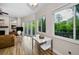 Bright living room with wood floors and view to deck, outdoor landscape and foliage at 2997 Eagle Estates E Cir, Clearwater, FL 33761