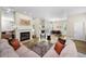 Spacious living area with fireplace, wood floors, comfortable seating, and a dining area at 2997 Eagle Estates E Cir, Clearwater, FL 33761