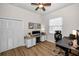 Inviting office space featuring a ceiling fan, closet, and two desks with storage and modern fixtures at 2997 Eagle Estates E Cir, Clearwater, FL 33761