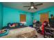 Aqua colored bedroom with a ceiling fan, wooden blinds, and multiple pillows on bed at 333 Acropolis Dr, Dunedin, FL 34698