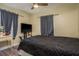 Bedroom featuring a ceiling fan, dark curtains, and a large bed with a dark patterned comforter at 333 Acropolis Dr, Dunedin, FL 34698