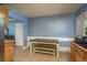 Dining area with tile flooring, light blue walls, and a table with attached benches at 333 Acropolis Dr, Dunedin, FL 34698