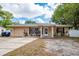 Charming single-story home features an attached garage, manicured landscaping, and welcoming front entrance at 333 Acropolis Dr, Dunedin, FL 34698