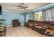 Relaxing living room features cool blue walls, tile floors, and a cozy sectional sofa at 333 Acropolis Dr, Dunedin, FL 34698