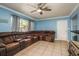 Spacious living room showcases tile flooring, a generous window, and a comfortable sectional sofa at 333 Acropolis Dr, Dunedin, FL 34698