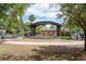 Charming public park with a covered stage area, landscaping, and pathways at 333 Acropolis Dr, Dunedin, FL 34698