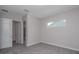 Bedroom features neutral walls and carpet flooring. Two open doors lead to adjacent rooms at 3926 Southern Valley Loop, Brooksville, FL 34601