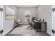 Modern home office setup with neutral decor, large window for natural light, and stylish yet functional furniture at 3926 Southern Valley Loop, Brooksville, FL 34601