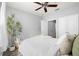 Bright bedroom featuring a ceiling fan, neutral walls, and a decorative plant in a white pot near the window at 4221 W Spruce St # 1229, Tampa, FL 33607