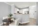 Open-concept dining area featuring luxury vinyl plank flooring, modern lighting, and access to the kitchen at 4221 W Spruce St # 1229, Tampa, FL 33607