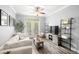 Bright living room features a modern ceiling fan, luxury vinyl plank flooring, and a sliding glass door to the outside at 4221 W Spruce St # 1229, Tampa, FL 33607