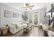 Bright living room features a modern ceiling fan, luxury vinyl plank flooring, and a sliding glass door to the outside at 4221 W Spruce St # 1229, Tampa, FL 33607